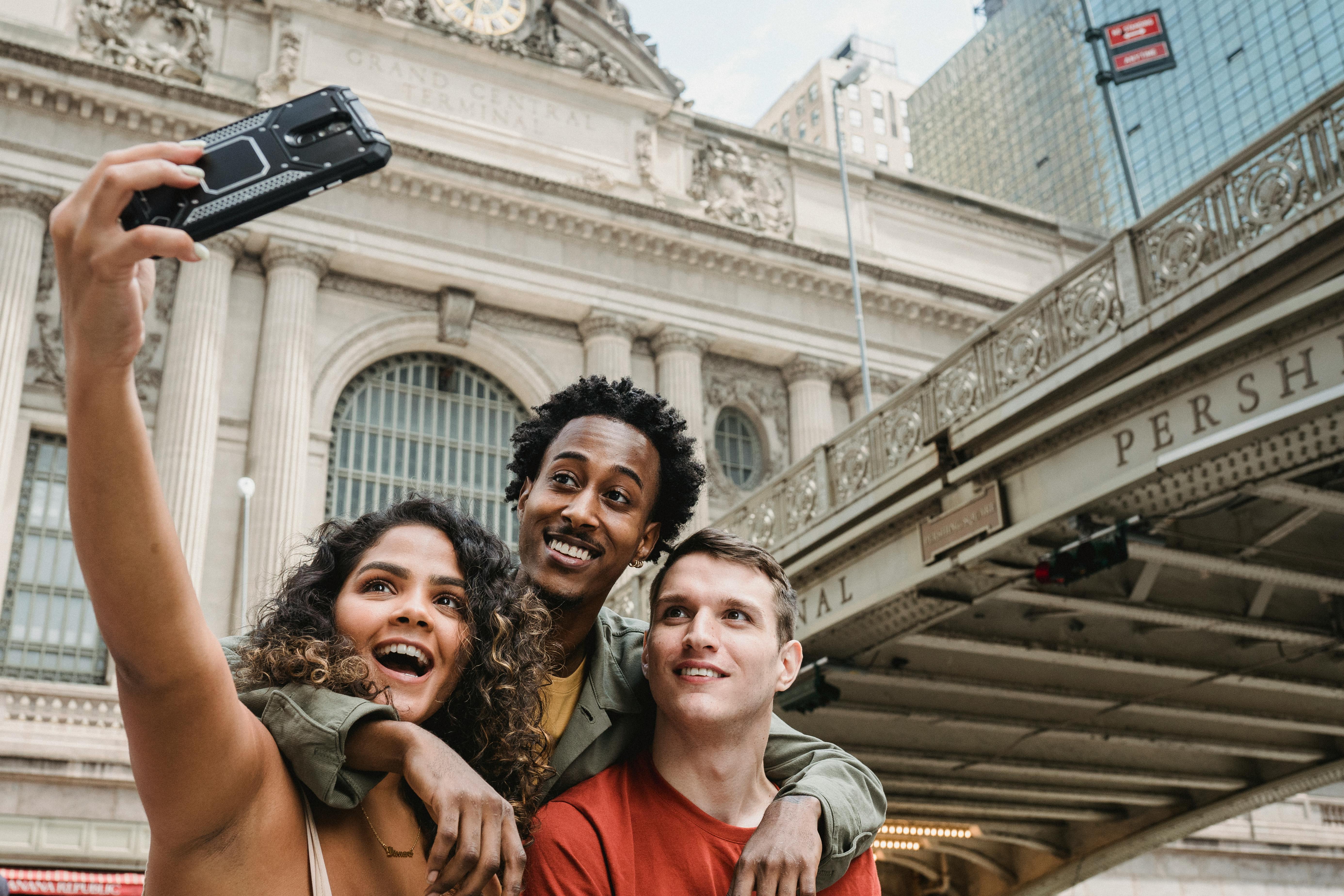 Group of diverse travelers smiling at airport with luggage, ready for adventure