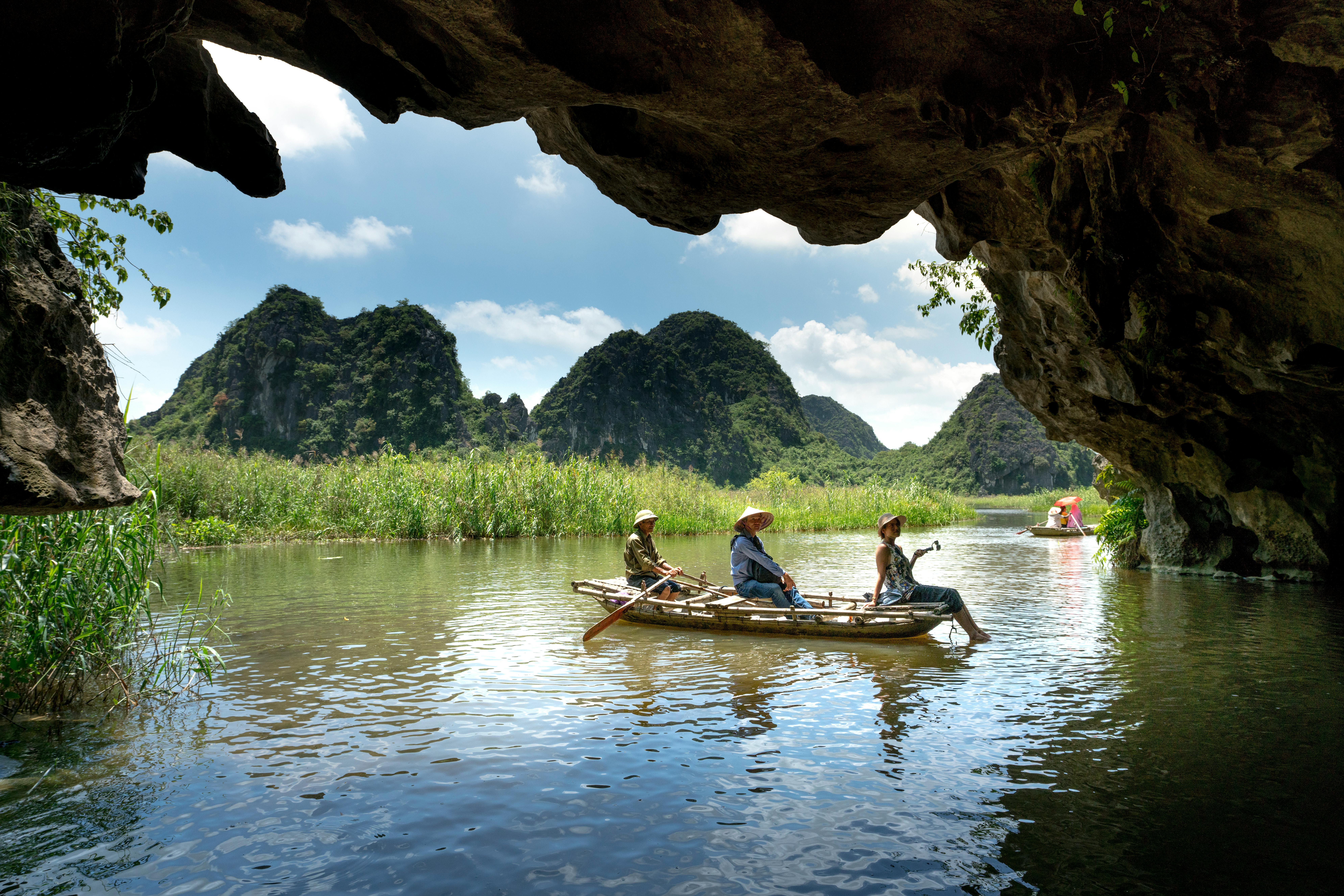Person on a boat in a turquoise water cave