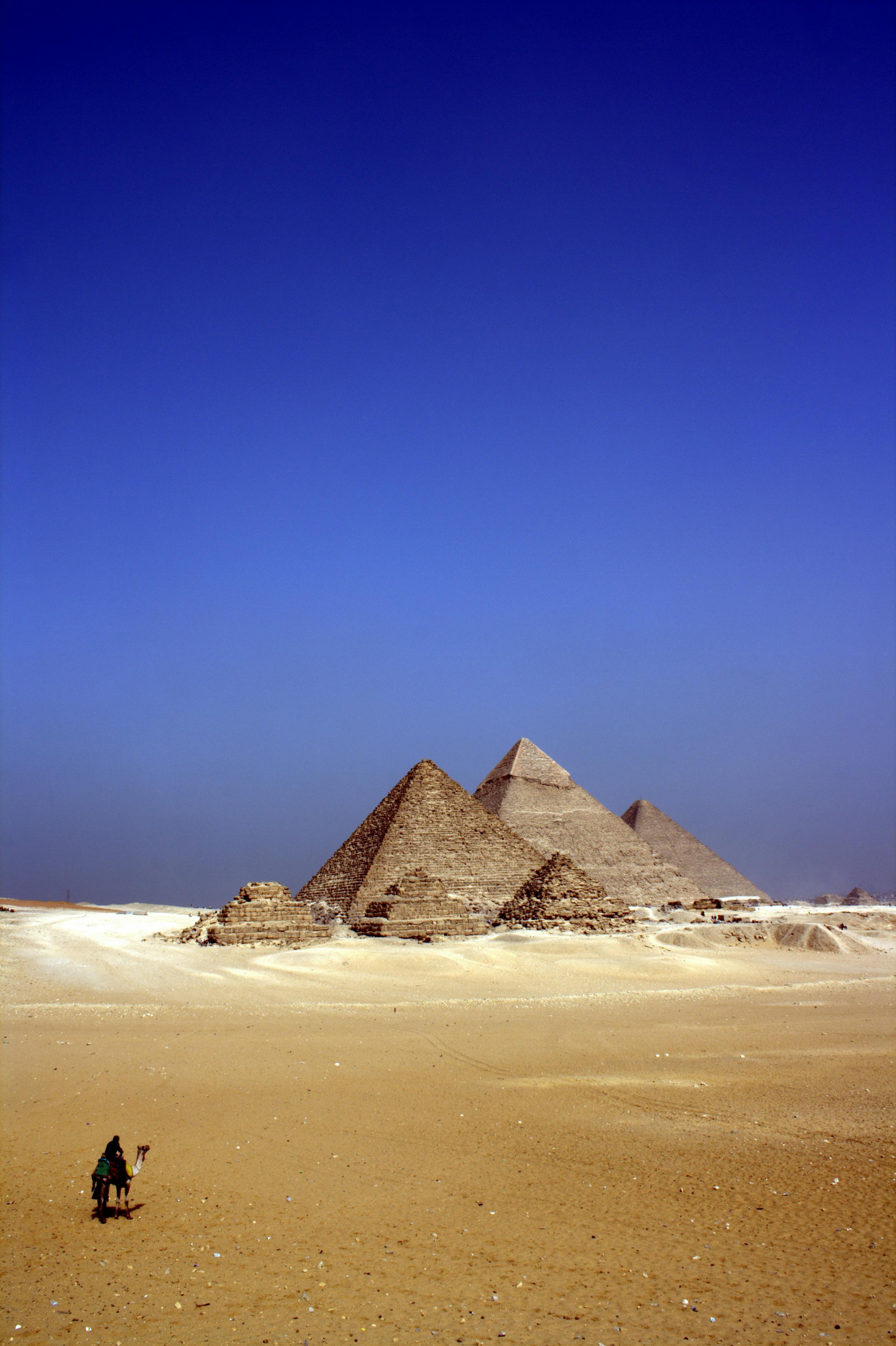 A couple exploring the ancient pyramids of Giza in Egypt at sunset